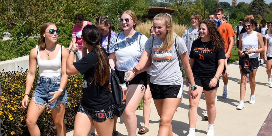 Students walk in front of amiptheater on their way to event downtown