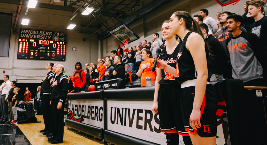 Side by side, senior duo sings National Anthem for final time