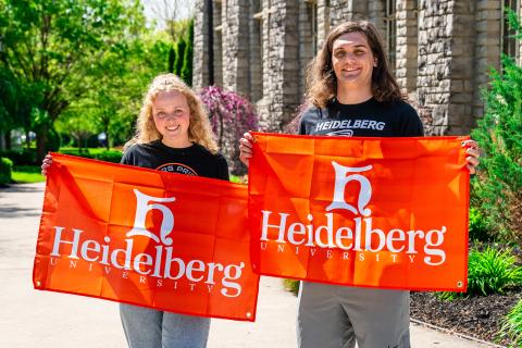 students holding heidelberg flags