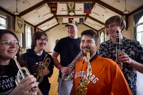 students holding band instruments